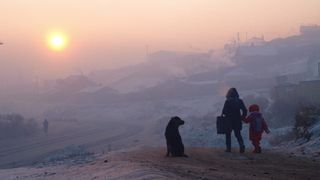 Children in Ulaanbaatar's smoggy streets at dawn